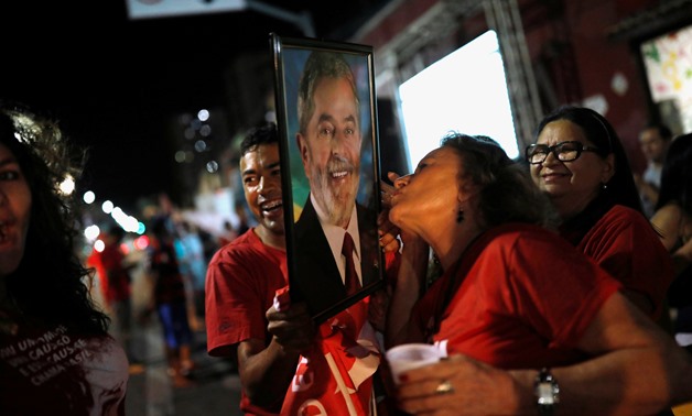 A woman kisses a photograph of former Brazilian president Luiz Inacio Lula da Silva, in Fortaleza, Brazil October 7, 2018. REUTERS/Nacho Doce
