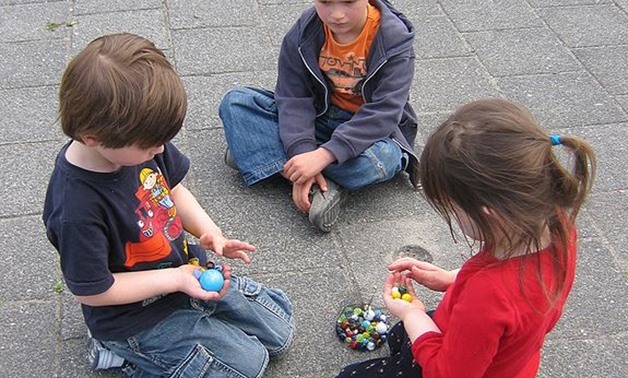 Kids playing with marbles- CC via Wikimedia
