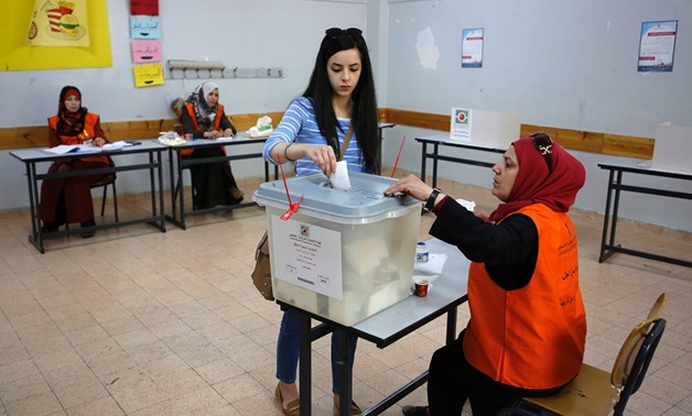 A Palestinian woman casts her ballot during the municipal elections in Ramallah -AFP