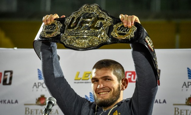 Unbeaten UFC lightweight champion Khabib Nurmagomedov of Russia shows his belt to fans after receiving a hero's welcome in Dagestan following his fourth-round victory over Conor McGregor of Ireland.
AFP / Vasily MAXIMOV
