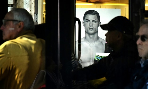 A Rome bus drives past an advertising poster for an underwear brand, showing a picture of Juventus' Portuguese forward Cristiano Ronaldo
AFP/File / Alberto PIZZOLI
