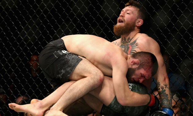 Khabib Nurmagomedov of Russia holds down Conor McGregor of Ireland in their UFC lightweight championship on October 6, where a post-match brawl broke out between the two fighters and their entourages
GETTY IMAGES NORTH AMERICA/AFP / Harry How
