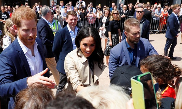 Britain's Prince Harry and wife Meghan, Duchess of Sussex greet members of the public during a visit at the Sydney Opera House in Sydney, Australia October 16, 2018. REUTERS/Phil Noble
