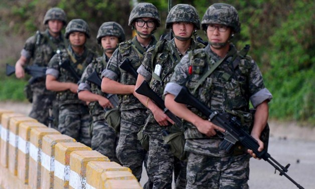 South Korean marines patrol along a bank of a shore on Yeonpyeong island just south of Northern Limit Line (NLL), South Korea, August 23, 2015. REUTERS/Min Gyeong-seok/ News1
