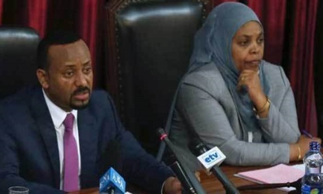 Ethiopia's newly elected Prime Minister Abiy Ahmed (L), flanked by parliament speaker, Muferiat Kamil, addresses the members of parliament inside the House of Peoples' Representatives, during a meeting for the approval of 2018/19 budget in Addis Ababa, Et