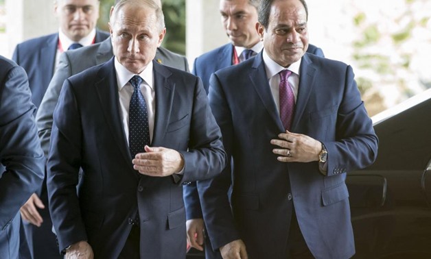 Russia's President Vladimir Putin (L) and Egypt's President Abdel Fattah al- Sisi walk during a meeting in Cairo, Egypt December 11, 2017.
