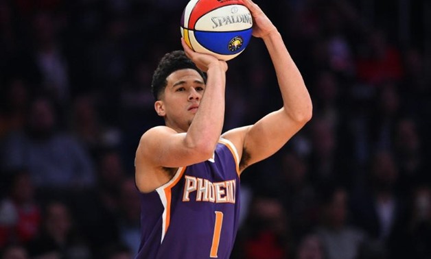 February 17, 2018; Los Angeles, CA, USA; Phoenix Suns guard Devin Booker (1) shoots during the three point contest at Staples Center.

