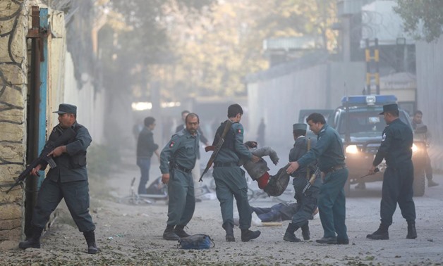 Afghan police carry an injuried person after a blast in Kabul. REUTERS/Mohammad Ismail
