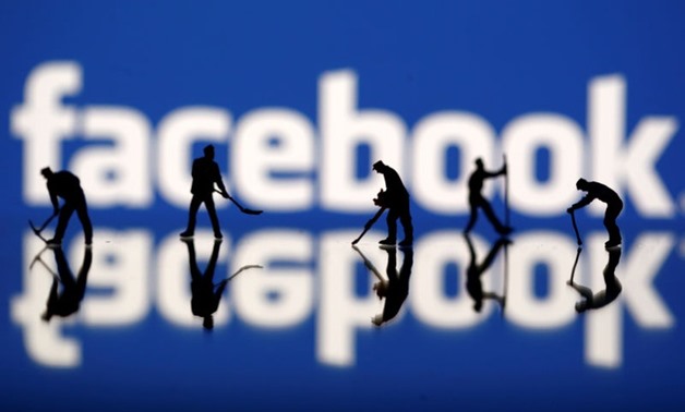 FILE PHOTO: Figurines are seen in front of the Facebook logo in this illustration taken March 20, 2018. REUTERS/Dado Ruvic
