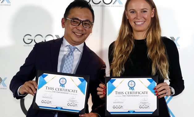 Tennis player Caroline Wozniacki attends a signing ceremony with CEO of GCOX Global Crypto Offering Exchange, Jeffrey Lin, to launch her own cryptocurrency in Singapore October 18, 2018. REUTERS/Edgar Su

