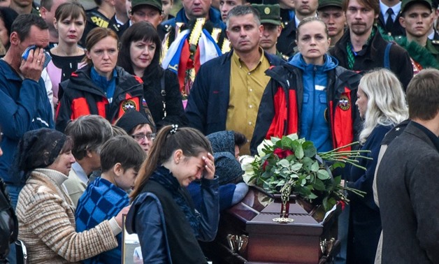 Mourners attended a funeral ceremony for the victims of the school shooting in the Russian-annexed Crimea city of Kerch
