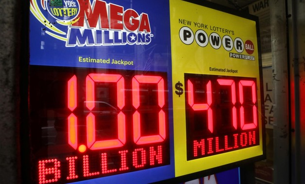 FILE PHOTO: Signs display the jackpots for Mega Millions and Powerball lottery drawings at a newsstands in midtown Manhattan in New York, U.S., October 19, 2018. REUTERS/Mike Sugar
