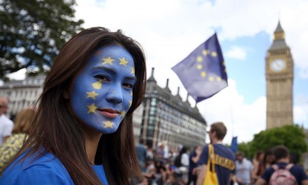FILE PHOTO - A woman with a painted face poses for a photograph during a 'March for Europe' demonstration against Britain's decision to leave the European Union, in central London, Britain July 2, 2016. REUTERS/Neil Hall
