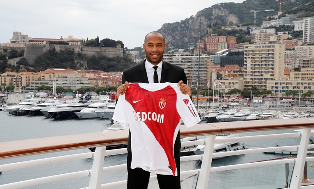 Soccer Football - Ligue 1 - AS Monaco - Thierry Henry Press Conference - Yacht Club de Monaco, Monaco - October 17, 2018 New AS Monaco head coach Thierry Henry poses for a photograph with the club shirt REUTERS/Eric Gaillard 