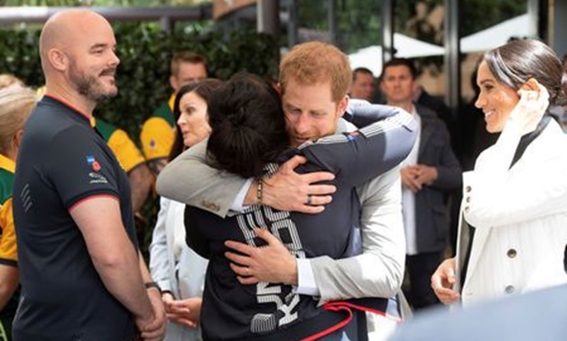 Britain's Prince Harry and Meghan, the Duchess of Sussex meet Team UK competitors while attending a lunchtime Reception hosted by the Prime Minister with Invictus Games competitors, their family and friends in the city's central parkland Sydney October 21