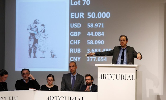 Auctioneer Arnaud Oliveux reacts at the final price in the bidding of the offset lithograph entitled "Stop and Search" (2007) by British street artist Banksy at the urban art auction organized by Artcurial in Paris, France, October 24, 2018. REUTERS/Charl