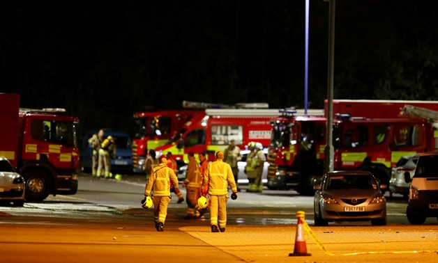 Soccer Football - Premier League - Leicester City v West Ham United - King Power Stadium, Leicester, Britain - October 27, 2018 Firefighters at the scene of where the helicopter belonging to Leicester City owner Vichai Srivaddhanaprabha crashed outside th