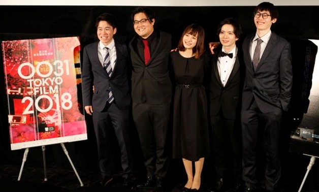 Director Kensei Takahashi (R) and cast members from "Sea", Seijyuro Mimori, Arisa Sato and Satoshi Abe and producer Taichi Tamura (L) attend a post-screening Q&A session after the film's world premiere at the 31st Tokyo International Film Festival in Toky
