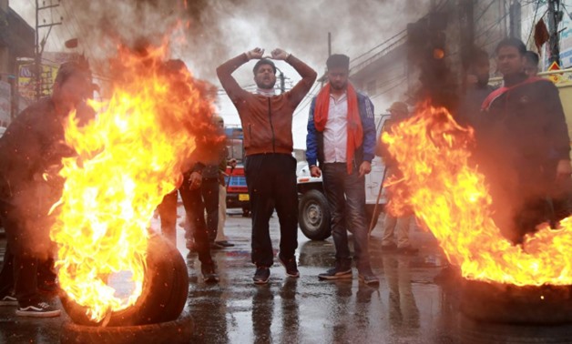 Demonstrators shout slogans next to burning tyres during a protest against the killing of a leader of India's ruling Hindu nationalist Bharatiya Janata Party's (BJP), and his brother by unidentified gunmen in Kishtwar town, in Jammu November 2, 2018. REUT