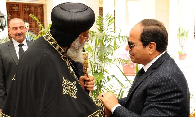 President Abdel Fattah El Sisi, right, shakes hands with Pope Tawadros II, left, at the Abassiya Cathedral in Cairo on April 13, 2017. The Egyptian presidency / Handout via Reuters