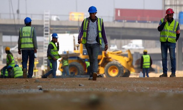 FILE - Construction workers are seen on the outskirts of Cairo - Reuters