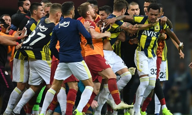 Fenerbahce and Galatasaray players fight at the end of the Turkish Spor Toto Super league fotball match between Galatasaray and Fenerbahce
AFP / OZAN KOSE
