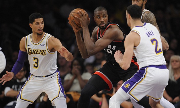 November 4, 2018; Los Angeles, CA, USA; Toronto Raptors forward Serge Ibaka (9) moves the ball against Los Angeles Lakers guard Lonzo Ball (2) and guard Josh Hart (3) during the second half at Staples Center. Mandatory Credit: Gary A. Vasquez-USA TODAY Sp