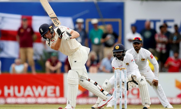 FILE PHOTO: Cricket - England v Sri Lanka, First Test - Galle, Sri Lanka - November 6, 2018. England's Jos Buttler (L) plays a shot next to Sri Lanka's wicketkeeper Niroshan Dickwella. REUTERS/Dinuka Liyanawatte/File Photo
