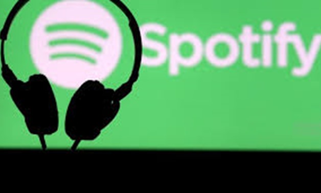 FILE PHOTO: A headset in front of a screen projection of Spotify logo, in this picture taken April 1, 2018. REUTERS/Dado Ruvic/File Photo
