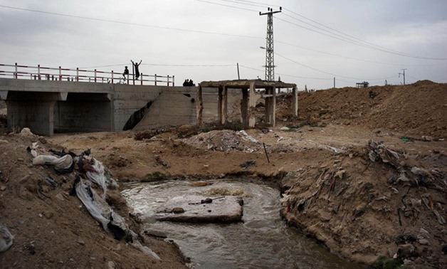 An open pool of sewage is seen in the garbage-filled Wadi Gaza area of the central Gaza Strip on Nov. 27, 2013. Photo Credit: Marco Longari / AFP 