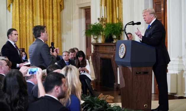 CNN correspondent Jim Acosta (C) was barred by the White House after a testy exchange with President Donald Trump
