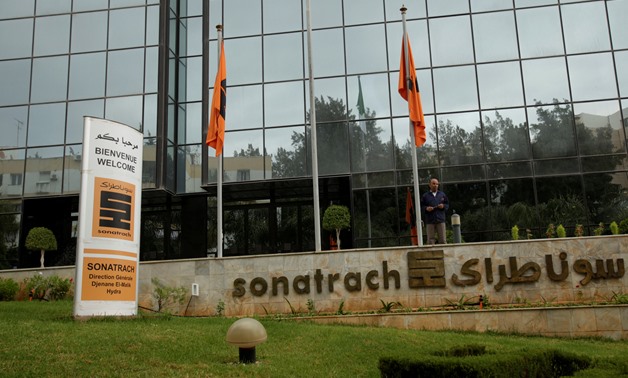 FILE PHOTO: An employee stands near the headquarter of the state energy company Sonatrach in Algiers
