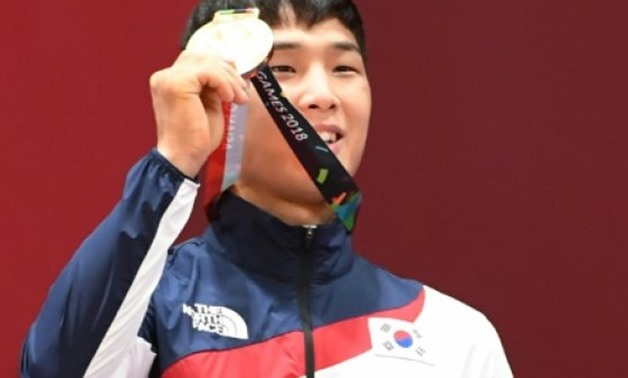 © AFP/File | Olympic silver medal-winning An Ba-ul celebrates victory at the 2018 Asian Games, where South Korean champions champions are also granted special exemptions from military service