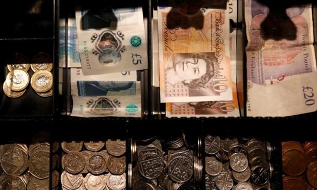 FILE PHOTO: Pound Sterling notes and change are seen inside a cash resgister in a coffee shop in Manchester, Britain, September 21, 2018. REUTERS/Phil Noble/File Photo
