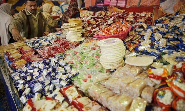 A vendor waits for customers to buy handmade sweets at a street market ahead of Mawlid al-Nabi, in Old Cairo, Egypt. Picture taken December 21, 2015. REUTERS/Amr Abdallah Dalsh