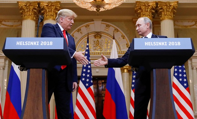 U.S. President Donald Trump and Russia's President Vladimir Putin shake hands during a joint news conference after their meeting in Helsinki, Finland, July 16, 2018. REUTERS/Kevin Lamarque/File Photo
