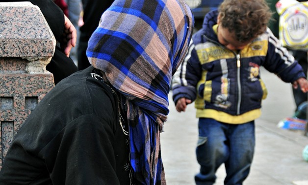 FILE – Beggar and her child, Al-Hussein, Cairo, November, 2011 – Flickr/MohannadKhatib