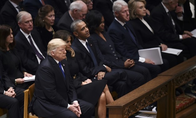 Presidential couples Donald and Melania Trump, Barack and Michelle Obama, and Bill and Hillary Clinton shared a front row pew at the state funeral for George H.W. Bush at Washington National Cathedral
