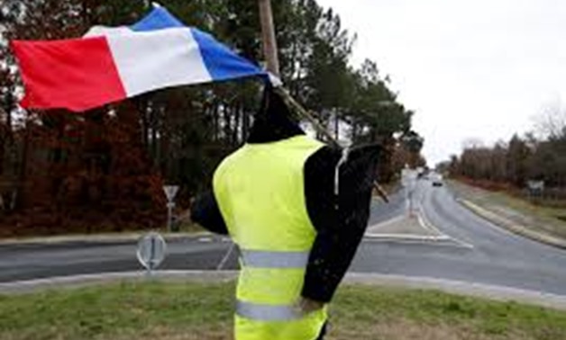 A figure with a yellow vest and a French flag is seen on a roundabout occupied by "yellow vests" protesters in Cissac-Medoc, France, December 7, 2018. REUTERS/Regis Duvignau
