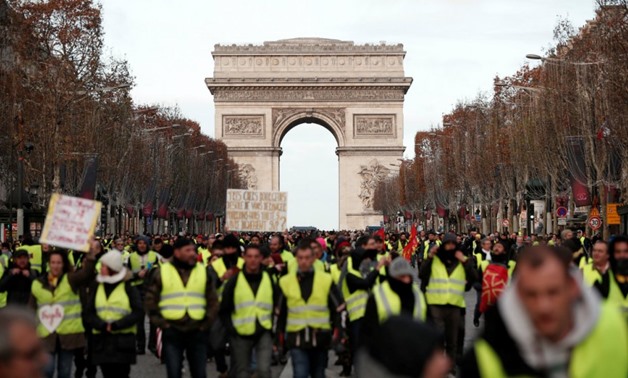 Benoit Tessier, Reuters | Protesters wearing yellow vests take part in a demonstration by the "yellow vests" movement on the Champs Elysees below the Arc de Triomphe in Paris, France, December 8, 2018.
