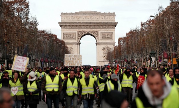 Benoit Tessier, Reuters | Protesters wearing yellow vests take part in a demonstration by the "yellow vests" movement on the Champs Elysees below the Arc de Triomphe in Paris, France, December 8, 2018.
