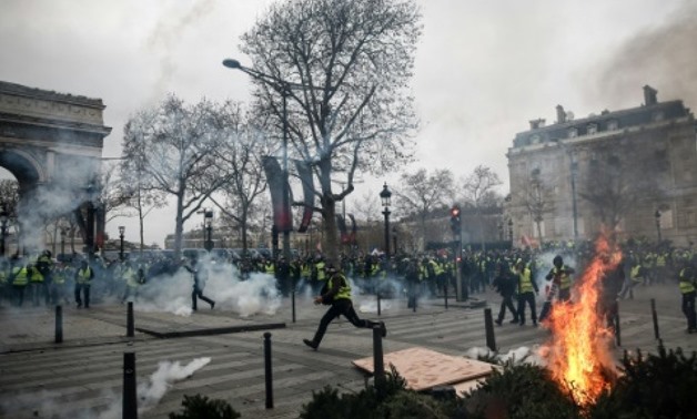 Protesters in Paris set fire to cars, burned barricades and smashed windows in pockets of violence, clad in their emblematic luminous safety jackets Protesters in Paris set fire to cars, burned barricades and smashed windows in pockets of violence, clad i