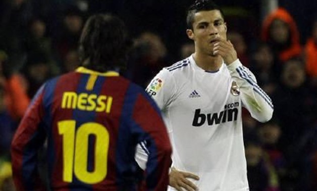 Real Madrid's Cristiano Ronaldo (L) reacts beside Barcelona's Leo Messi during their Spanish first division soccer match at Nou Camp stadium in Barcelona, November 29, 2010. REUTERS/Albert Gea/Files
