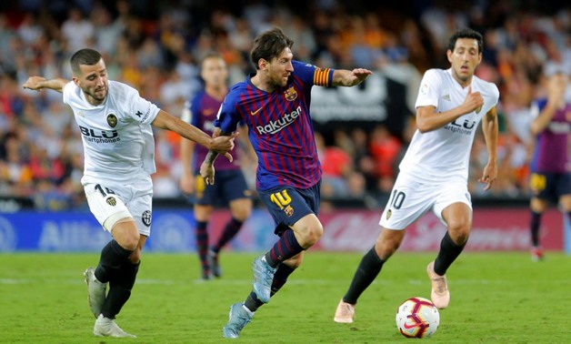 Soccer Football - La Liga Santander - Valencia v FC Barcelona - Mestalla, Valencia, Spain - October 7, 2018 Barcelona's Lionel Messi in action with Valencia's Jose Gaya REUTERS/Heino Kalis
