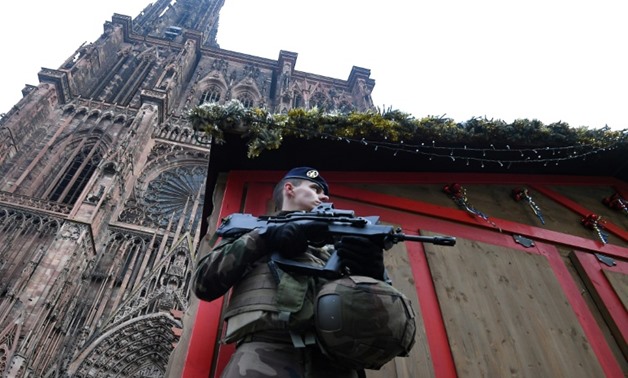 A French soldier in front of a boarded-up Christmas market stall outside the cathedral in Strasbourg, eastern France, on Wednesday cathedral in eastern
