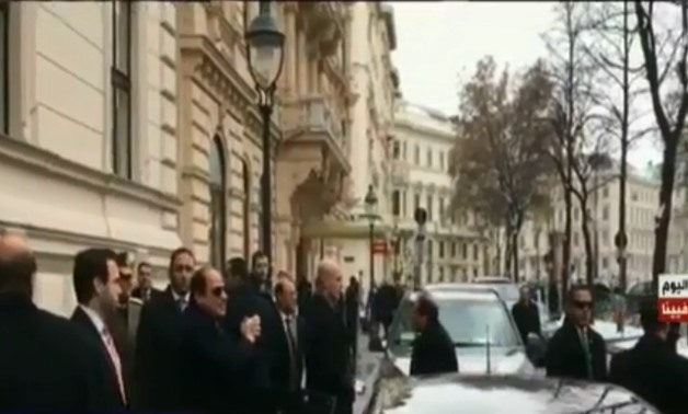 President Abdel Fatah al-Sisi waves back at expats greeting him in front of his residence in Vienna, Austria. December 16, 2018. TV screenshot.