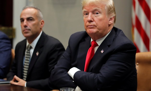 U.S. President Donald Trump listens to remarks at a roundtable discussion of the Federal Commission on School Safety Report with Andy Pollack, whose daughter Meadow was killed in the deadly school shooting at Marjory Stoneman Douglas High School, at the W