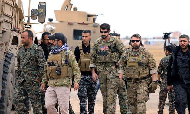FILE PHOTO: Syrian Democratic Forces and U.S. troops are seen during a patrol near Turkish border in Hasakah, Syria November 4, 2018. REUTERS/Rodi Said/File Photo
