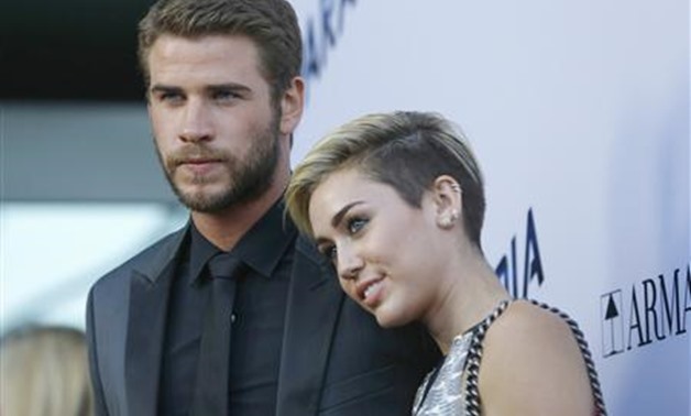 Cast member Liam Hemsworth poses with his fiancee, singer Miley Cyrus, at the premiere of "Paranoia" in Los Angeles, California in this file photo taken August 8, 2013. REUTERS/Mario Anzuoni/Files