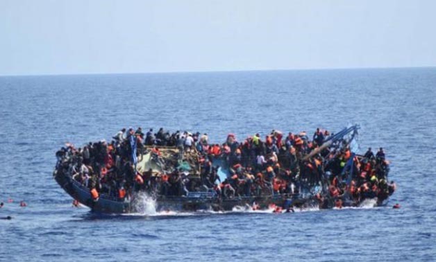 Migrants Are Seen On A Capsizing Boat Before A Rescue Operation By Italian Navy Ships "Bettica" And "Bergamini" (Unseen) Off The Coast Of Libya In This Handout Picture Released By The Italian Marina Militare On May 25, 2016 - REUTERS